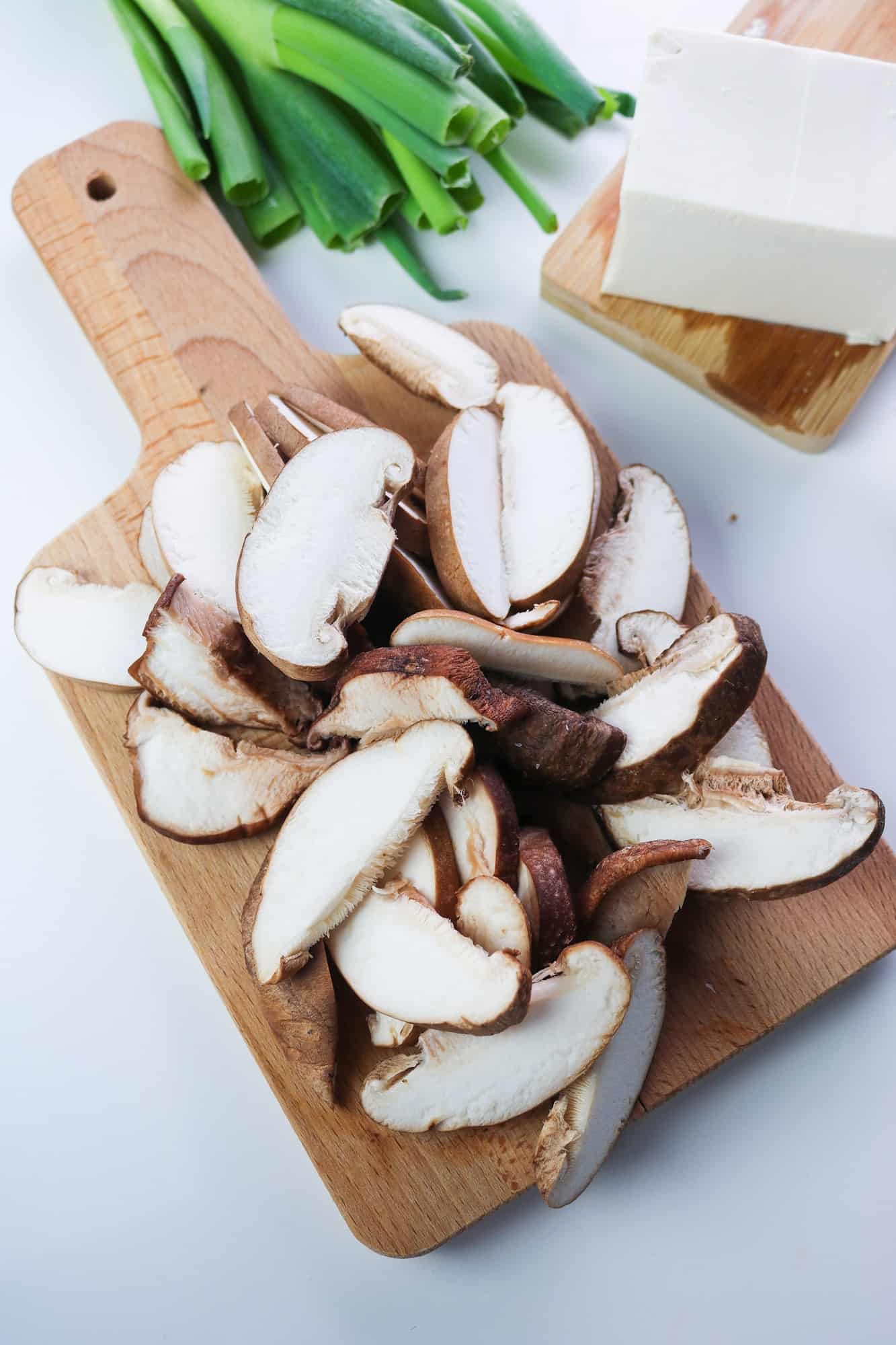 chopped shiitake mushrooms on a wooden board