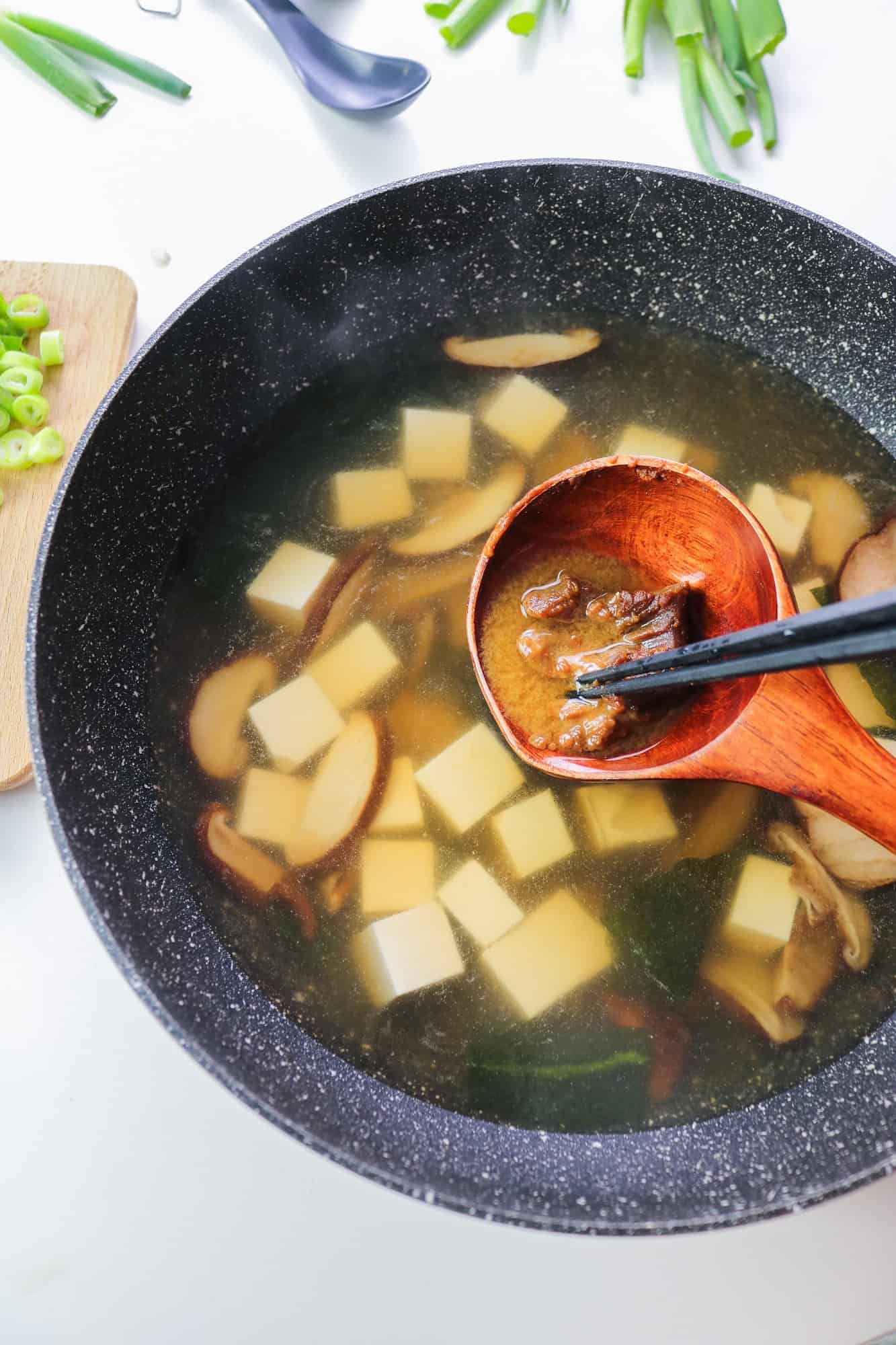 dissolving white miso paste in dashi broth