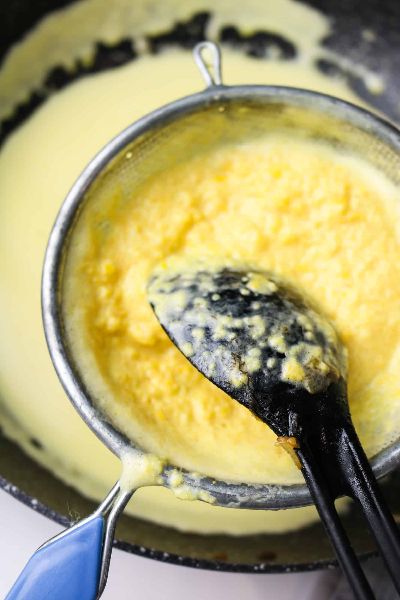 filtering turmeric and yellow pepper sauce