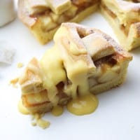 Slice of apple pie with custard drizzle