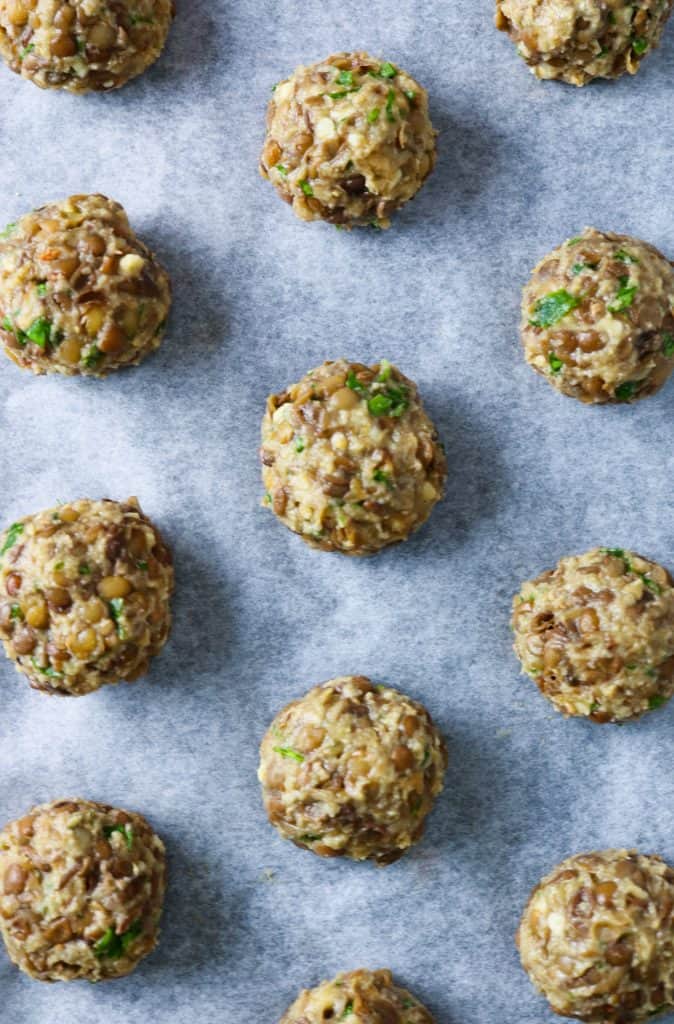 Picture of ready lentil balls arranged on a baking tray ready to be cooked in the oven