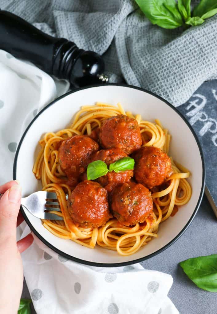 Lentil Meatballs in Rich Tomato Sauce over cooked spaghetti fork