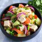 fresh italian potato salad with red onions, cucumbers, tofu, tomatoes and peas