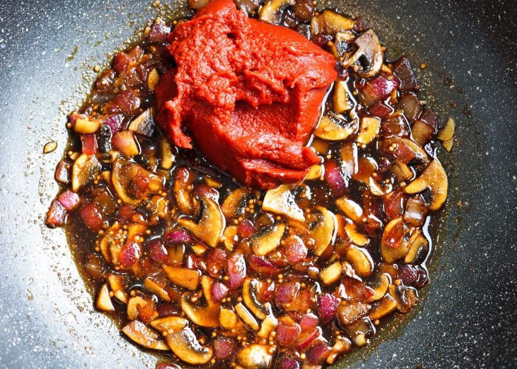tomato paste, onion, garlic, mushrooms, spices, vinegar in a pan saute