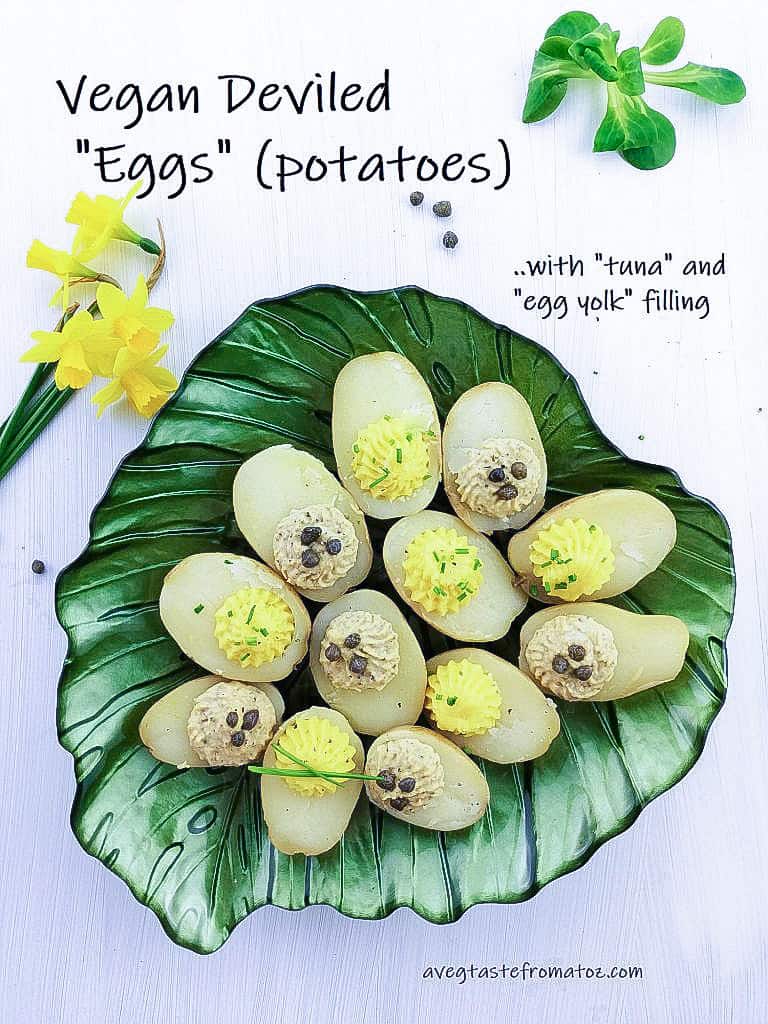 boiled potatoes with vegan tuna and egg yolk filling on a leaf shaped green plate, white background, peppercorns, lettuce and yellow flowers as decorations with black text for social media sharing