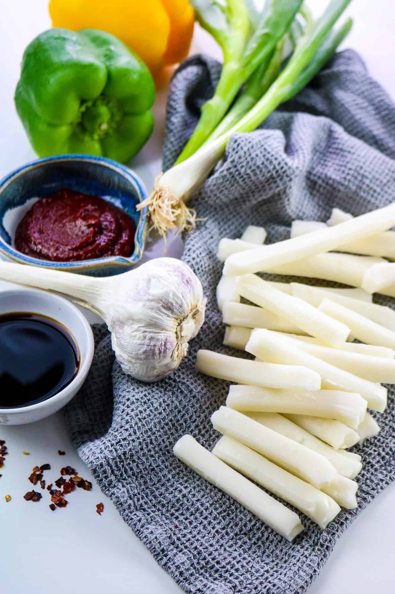 ingredients of the recipe all arranged on a white table and a grey cloth