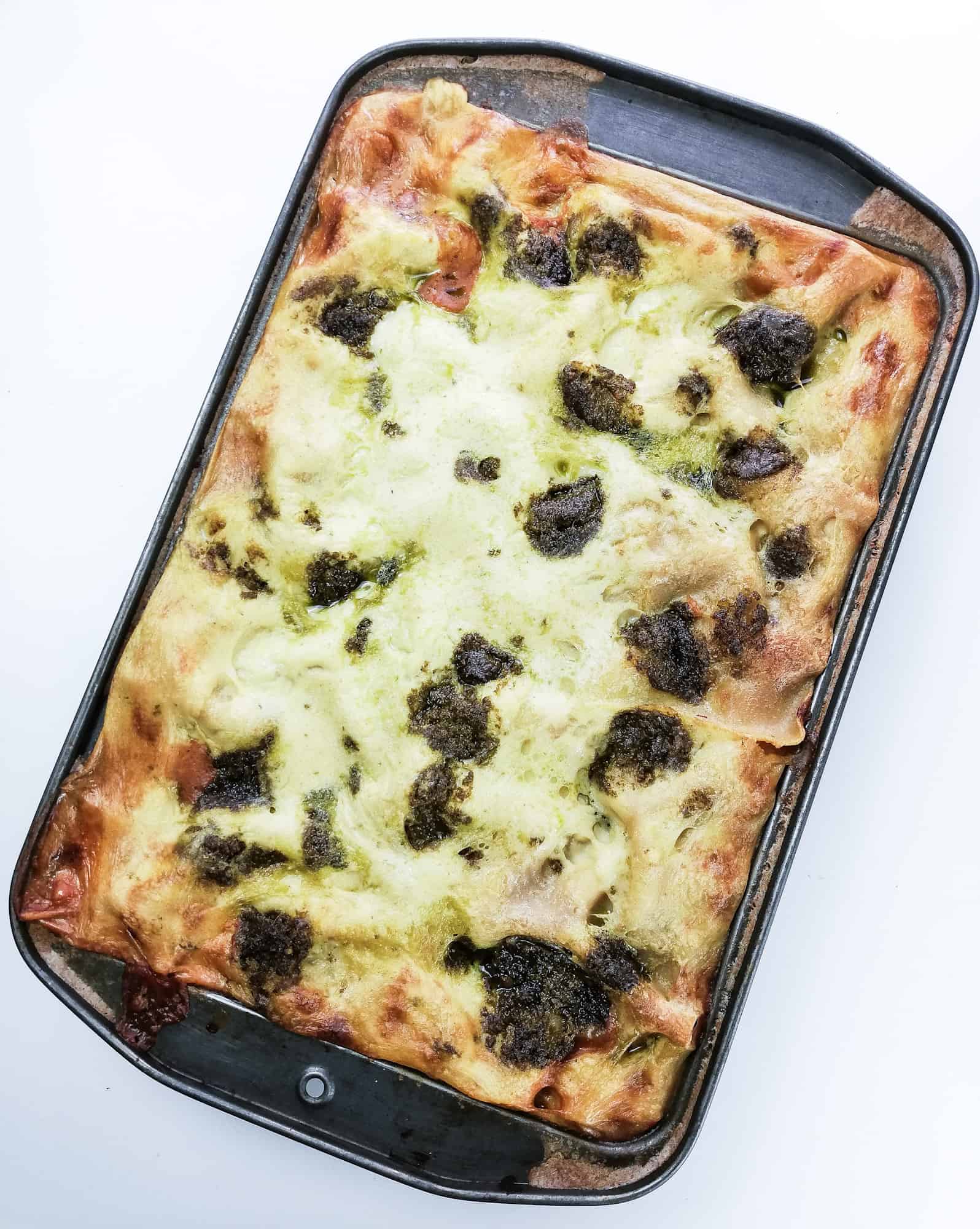 tray of veggie lasagna with pesto and mozzarella sauce