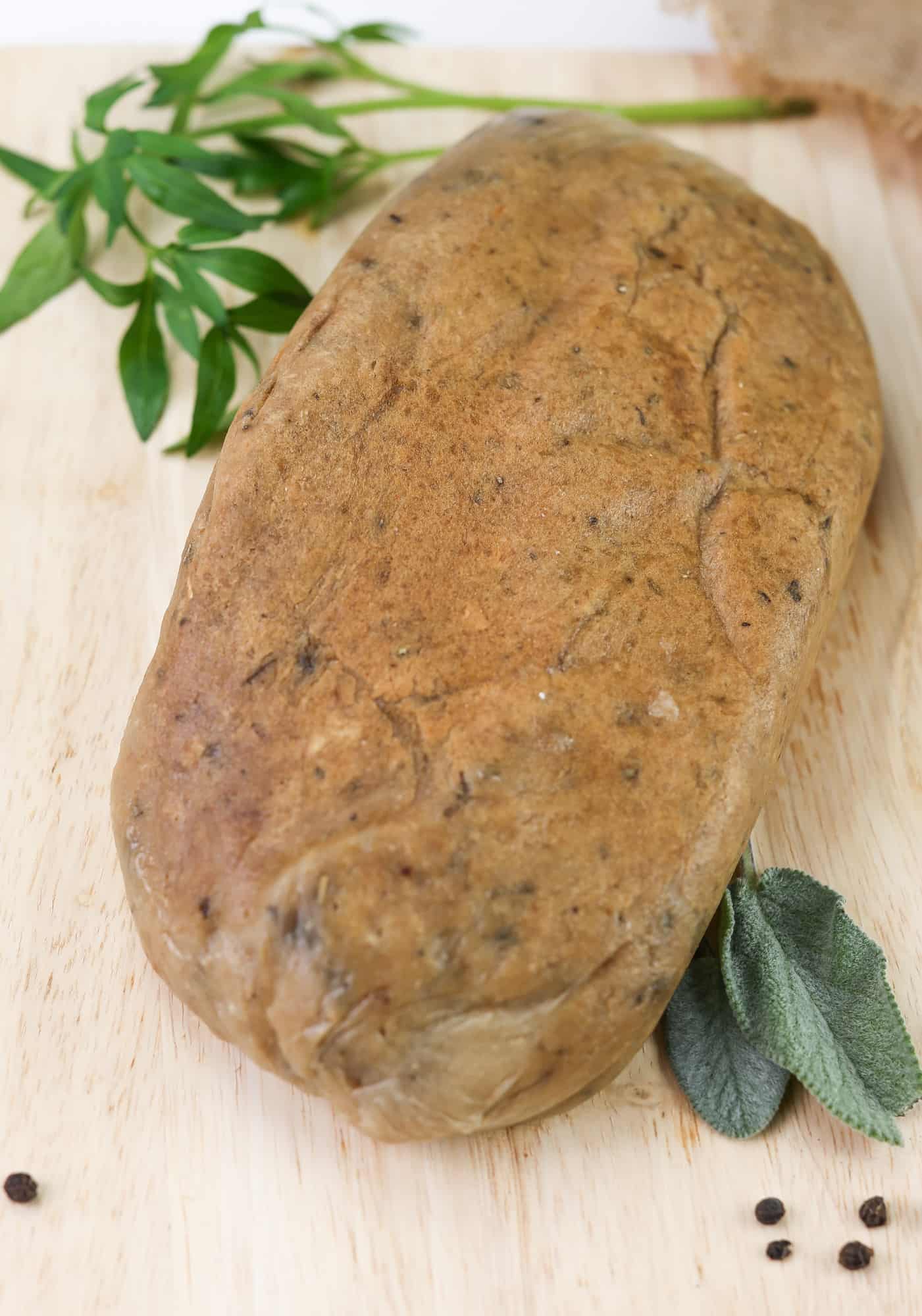 Turkey(less) loaf, vegan meat alternative that is also suitable for your gluten and soy free guests whole on a wooden board