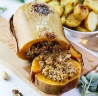 Vegan Roasted Butternut Squash: Sweet and herby roasted squash filled with a generous and fragrant plant mince, accompanied by a flavourful sage and white wine gravy, will be the absolute star of your Thanksgiving or Christmas table. #holiday #veganmain #thanksgiving #recipeinspo #plantbased #christmasmain #roastedsquash