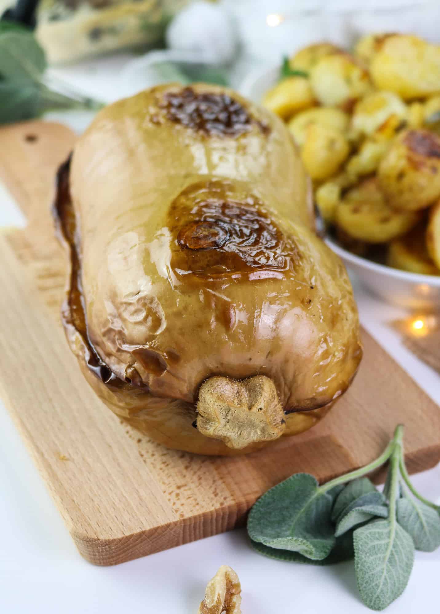 Whole Vegan Roasted Butternut Squash: Sweet and herby roasted squash filled with a generous and fragrant plant mince, accompanied by a flavourful sage and white wine gravy, will be the absolute star of your Thanksgiving or Christmas table. #holiday #veganmain #thanksgiving #recipeinspo #plantbased #christmasmain #roastedsquash