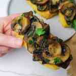 polenta bruschetta with mushrooms held