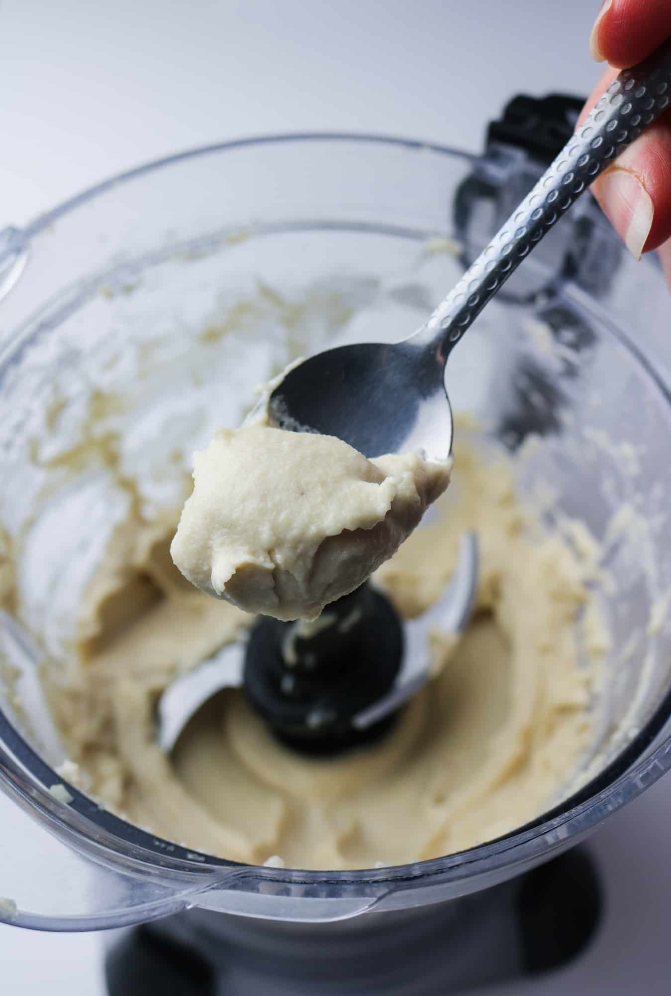 vegan cream cheese texture on spoon over blender