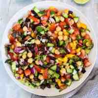 colourful bean salad with tomatoes, peppers, cucumber, onions, chickpeas