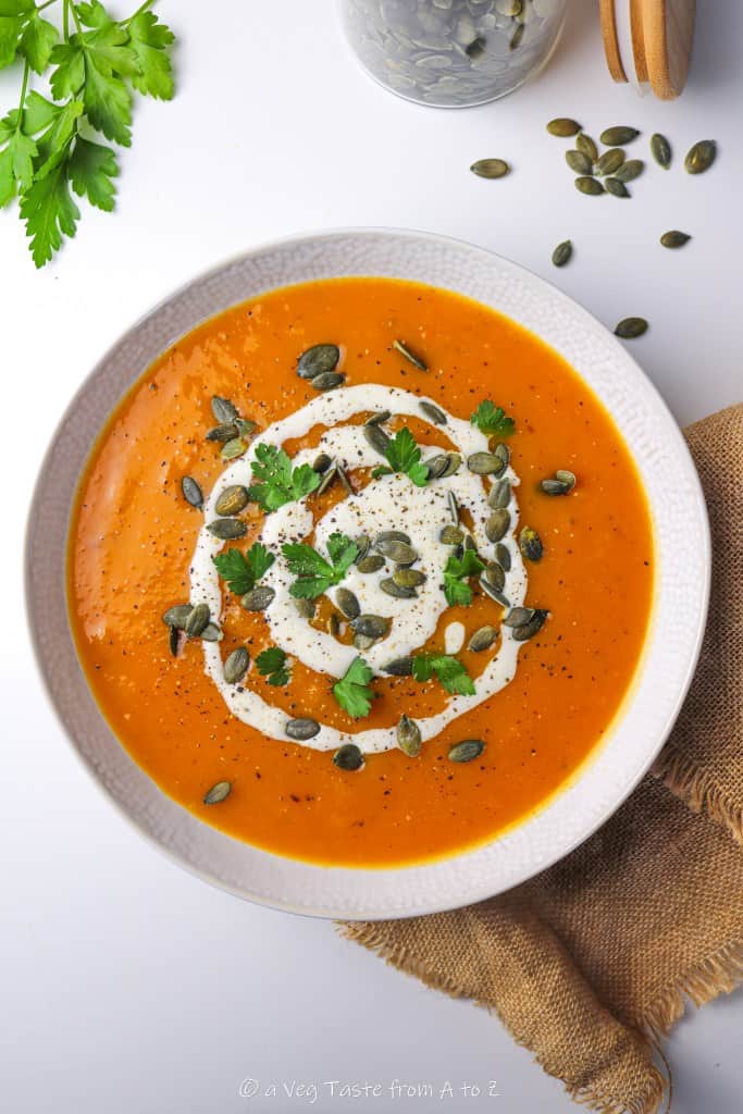 roasted butternut squash and coconut milk soup on white plate