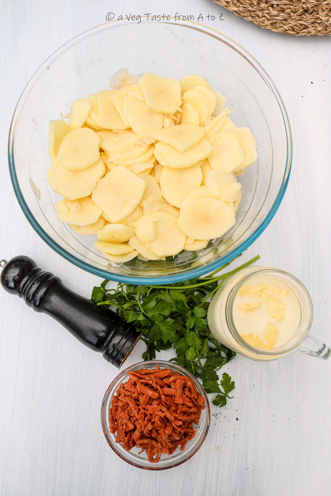 ingredients on white surface for vegan scalloped potatoes
