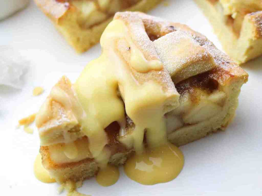 Slice of apple pie with custard drizzle