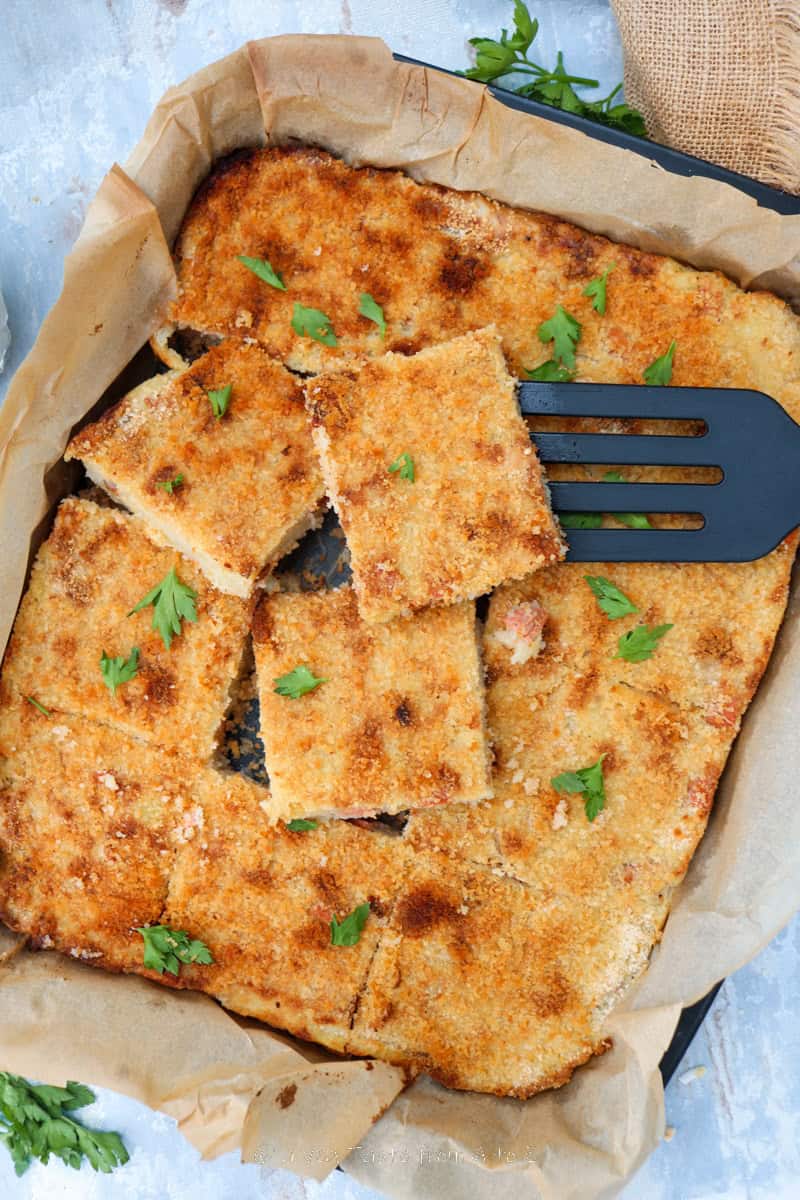 potato gateau cut in squares in a tray