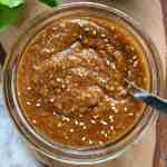 sesame and miso dressing in a glass bowl with a spoon