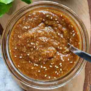 sesame and miso dressing in a glass bowl with a spoon