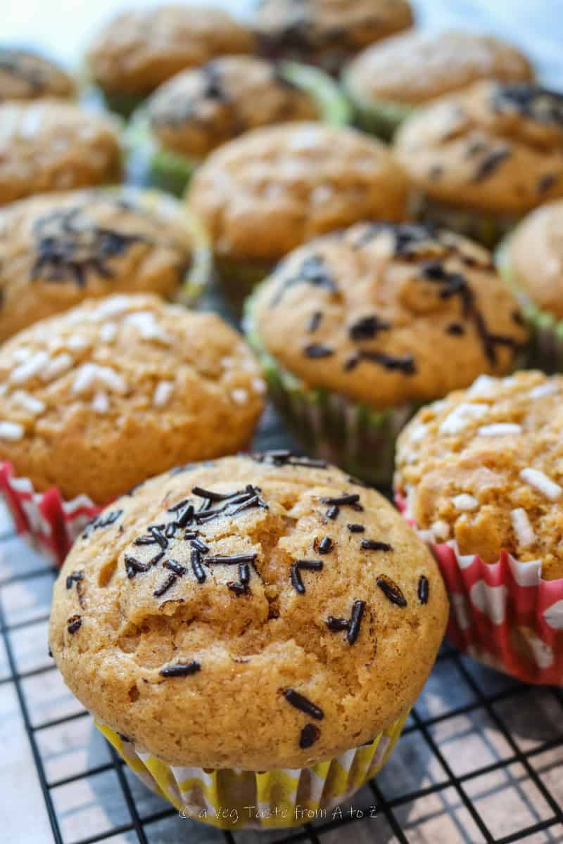 close up to baked pumpkin spice muffins on cooling rack