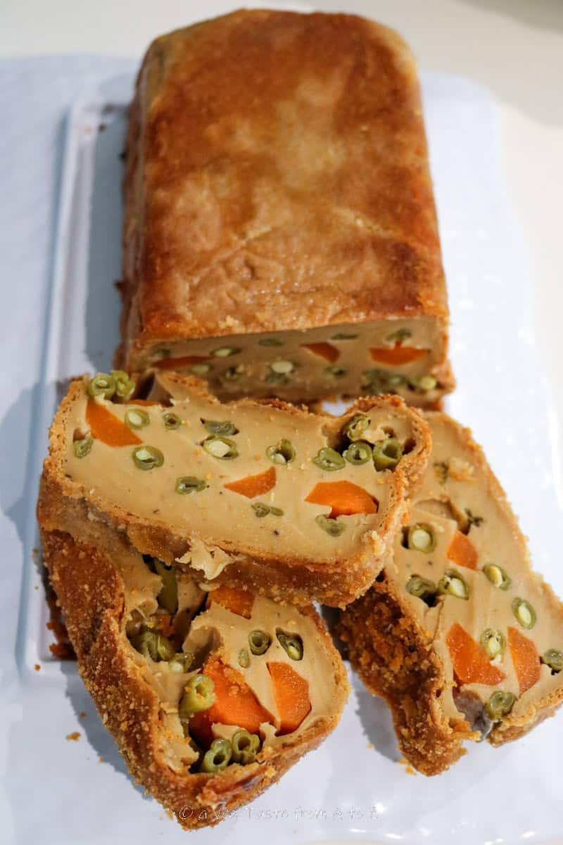tofu loaf on a white board half sliced