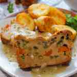 tofu loaf slice stuffed with green beans and carrot, served with gravy and roasted potatoes