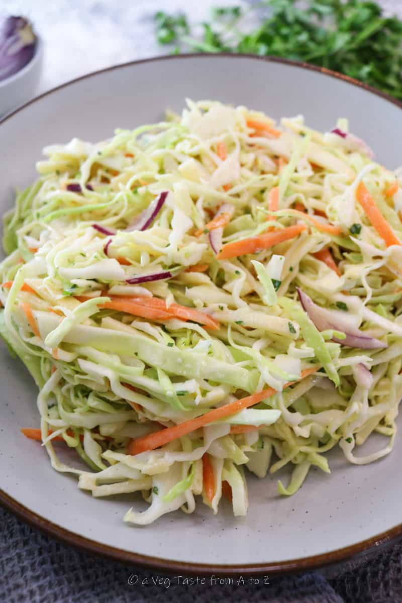 close up to vibrant sweetheart cabbage slaw on serving plate
